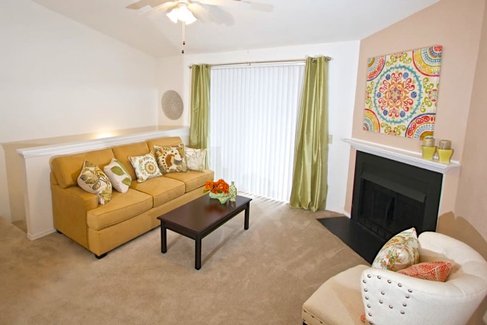 A furnished living room with a sliding door to the balcony at Royal Pointe in Virginia Beach, Virginia