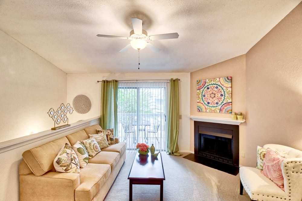 A furnished apartment living room with a fireplace at Royal Pointe in Virginia Beach, Virginia