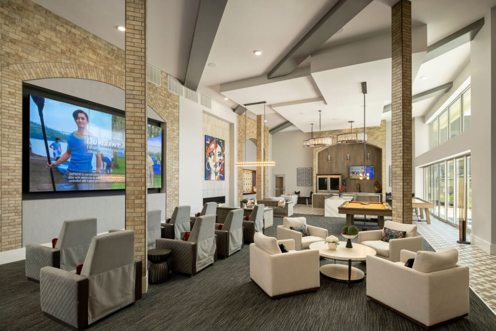 Resident lounge with large TV and games at Olympus Chandler at the Park in Chandler, Arizona