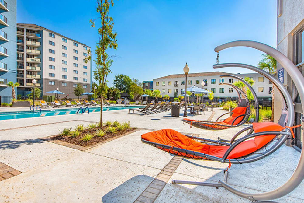 hanging chairs by the pool at Acasă Vista Towers in Columbia, South Carolina