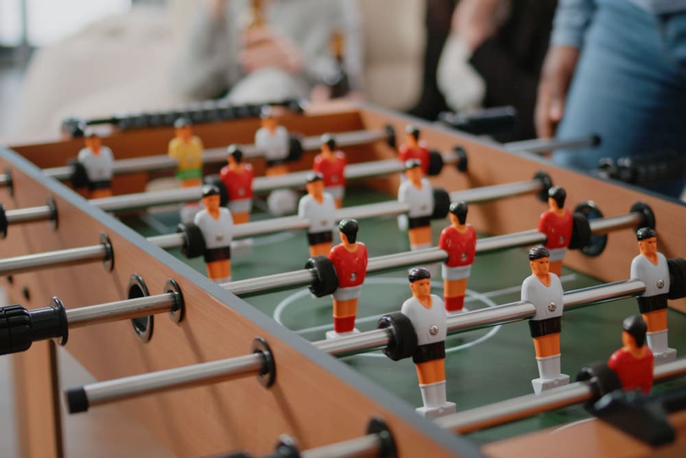 Resident playing a game of table foosball at Bella on Canyon in Puyallup, Washington