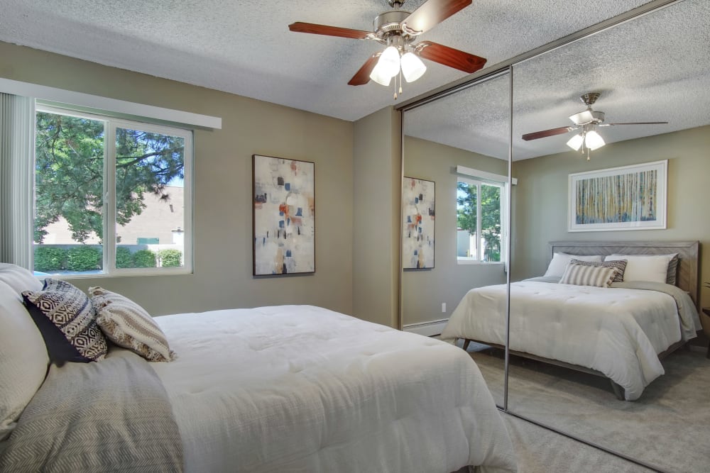Bedroom with wall art and light accents at Marina's Edge Apartment Homes in Sparks, Nevada
