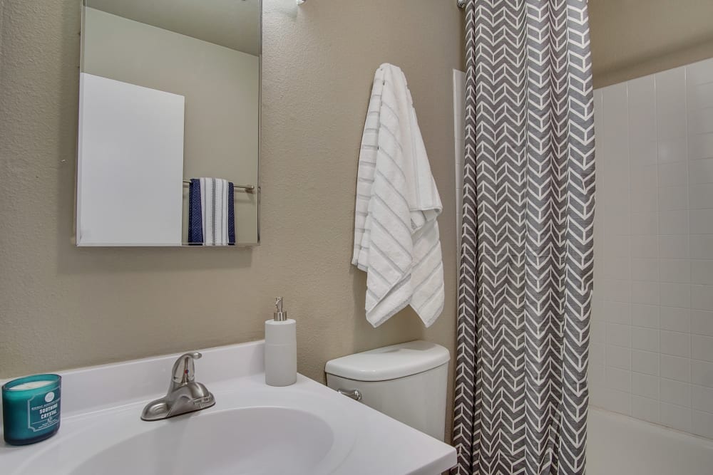 Bathroom with beautiful curtain at Marina's Edge Apartment Homes in Sparks, Nevada