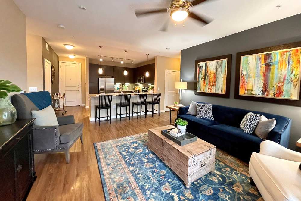 Living room attached with the kitchen at  The Abbey at Spring Town Center in Spring, Texas