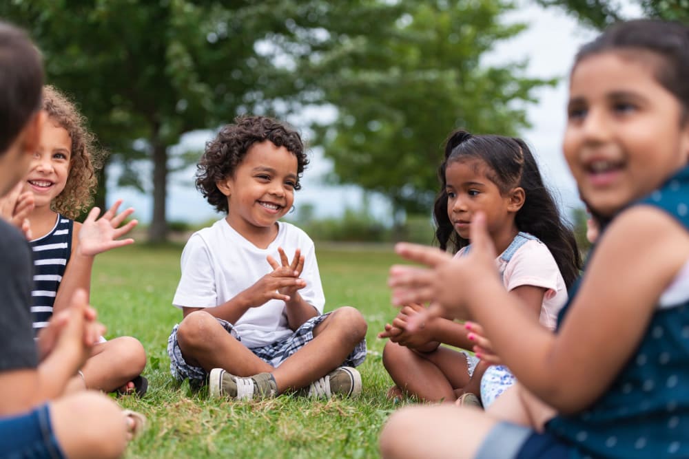 Happy kids playing in park near Creekside Park Apartments in Napa, California