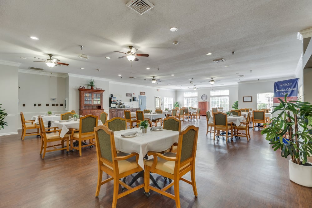 Dining tables and chairs in the dining room at Village Cove Assisted Living in Hilton Head Island, South Carolina