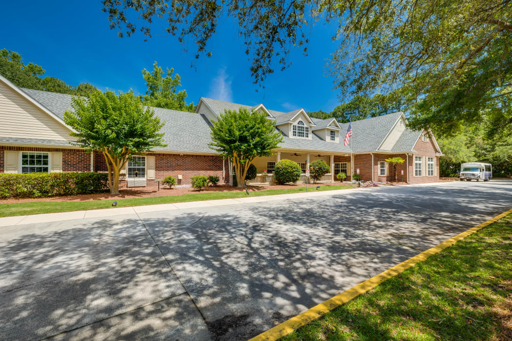 The exterior of Village Cove Assisted Living in Hilton Head Island, South Carolina and parking spaces
