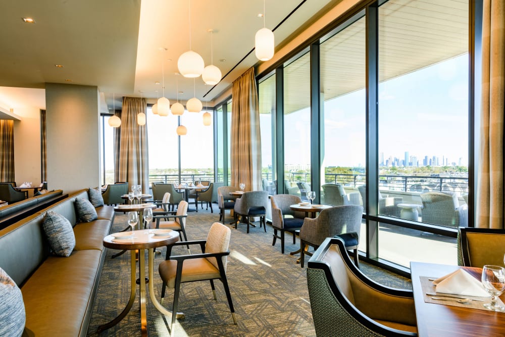 Large resident dining area with views of the city at Clearwater at The Heights in Houston, Texas