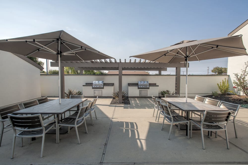 Patio tables and chairs with umbrellas at Sheridan Park in Salinas, California