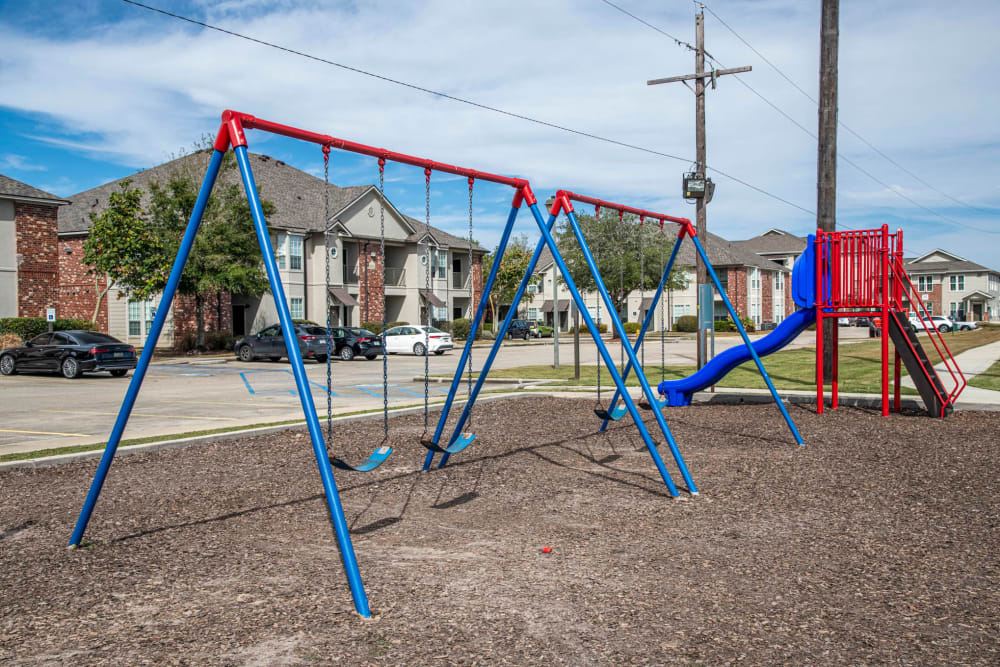 A swing set and playground at The Highland Club in Baton Rouge, Louisiana