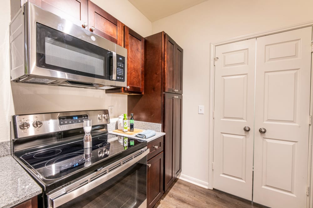 Stainless-steel appliances in an apartment kitchen at The Highland Club in Baton Rouge, Louisiana