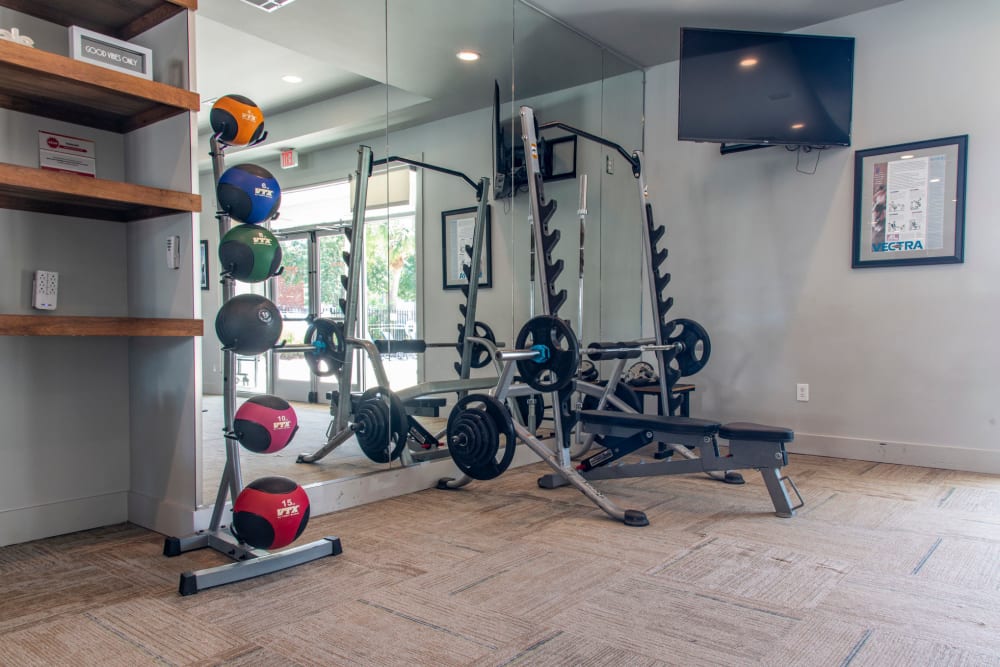 Medicine balls and a weight lifting bench in the fitness center at The Highland Club in Baton Rouge, Louisiana