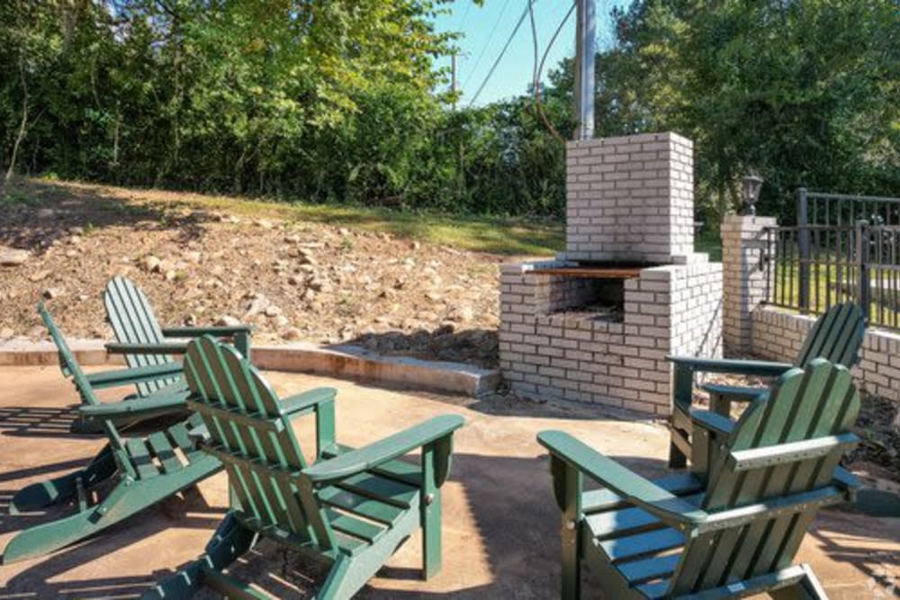 Lounge chairs in front of an outdoor fireplace at Ivy Terrace in Chattanooga, Tennessee