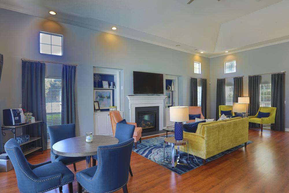 Community clubhouse with a wall mounted tv at Acasă Willowbrook Apartments in Simpsonville, South Carolina