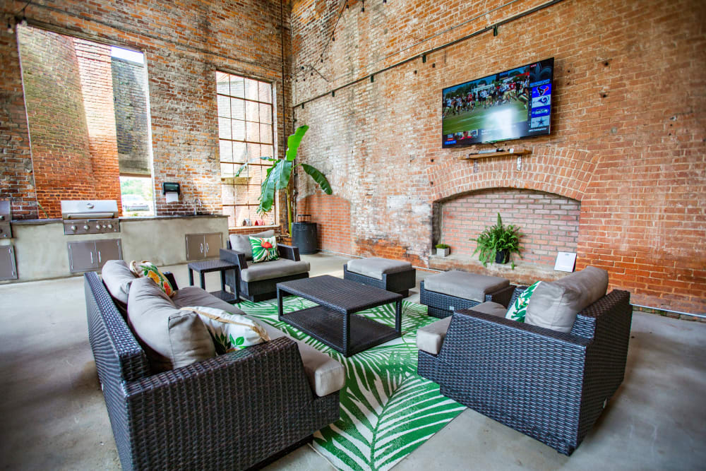 Clubhouse common area with grill station at West Village Lofts at Brandon Mill in Greenville, South Carolina