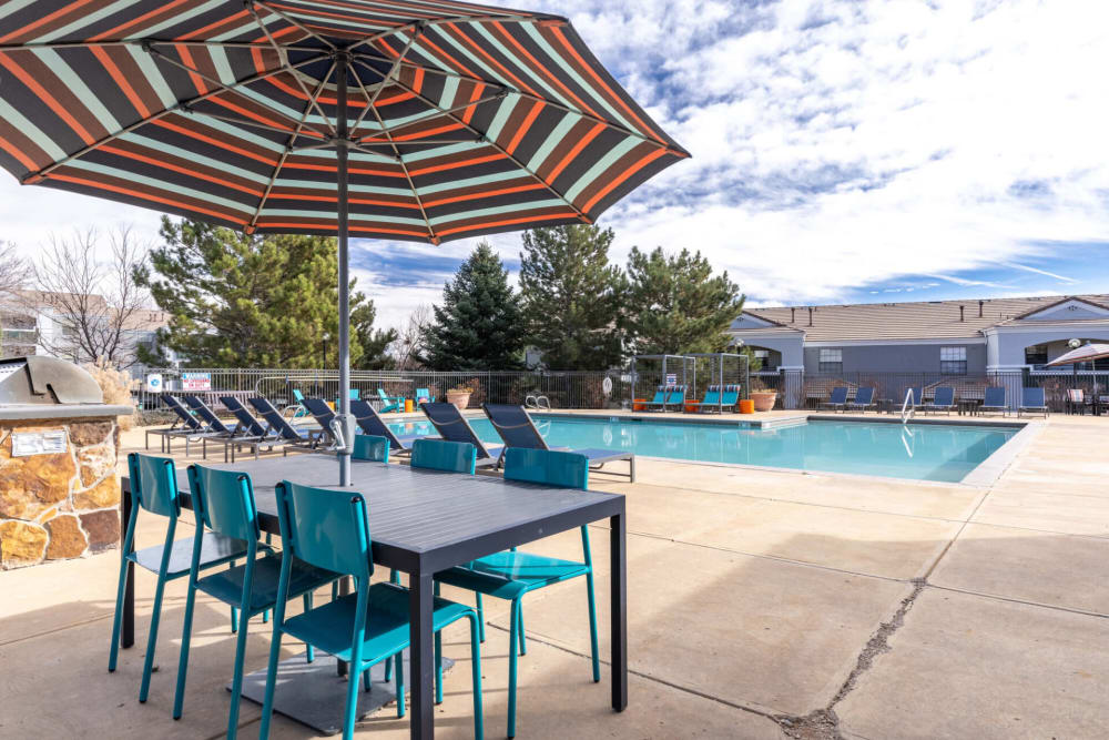 Pool side tables and umbrellas at Artemis at Spring Canyon in Colorado Springs, Colorado