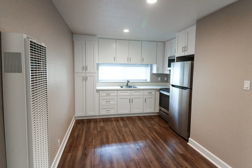 Spacious apartment with wood-style flooring at Briarwood Apartments in Livermore, California