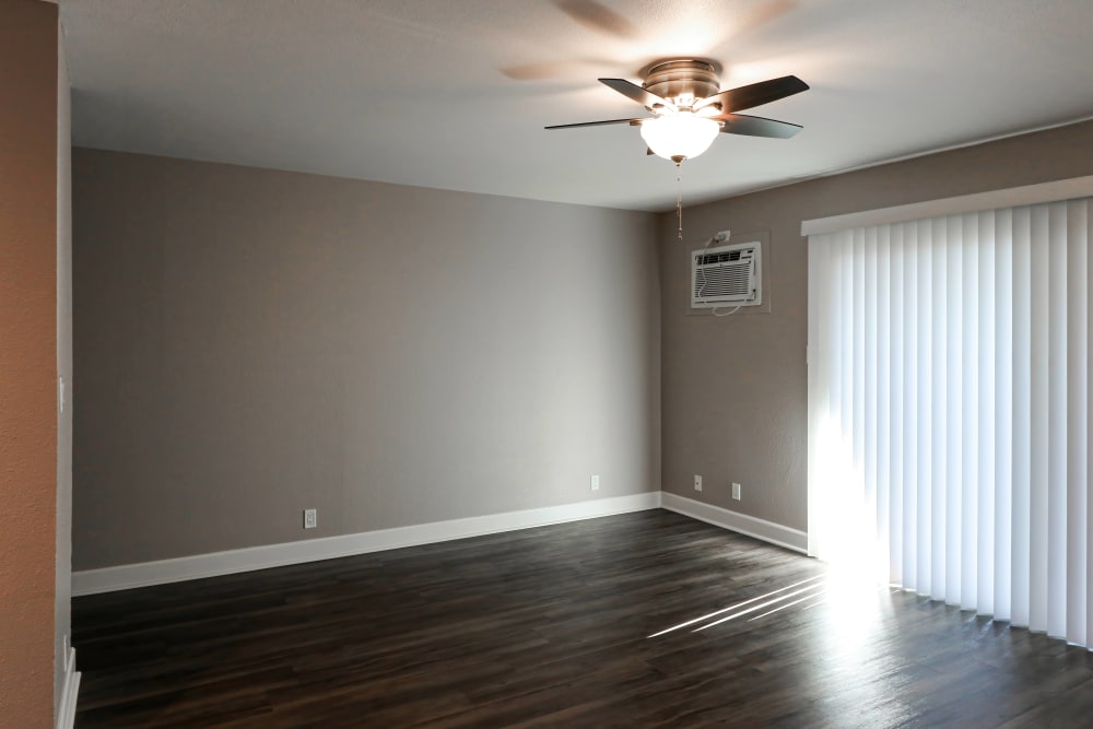 Bedroom with a large window and ceiling fan at Briarwood Apartments in Livermore, California