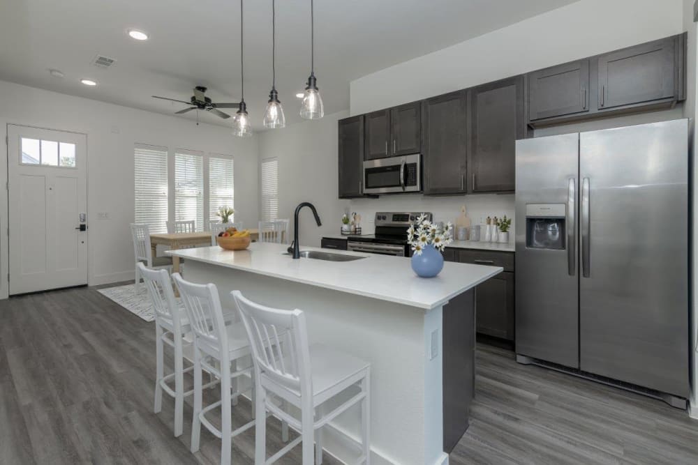 Spacious kitchen with center island and new appliances at Elevate at Skyline in McKinney, Texas