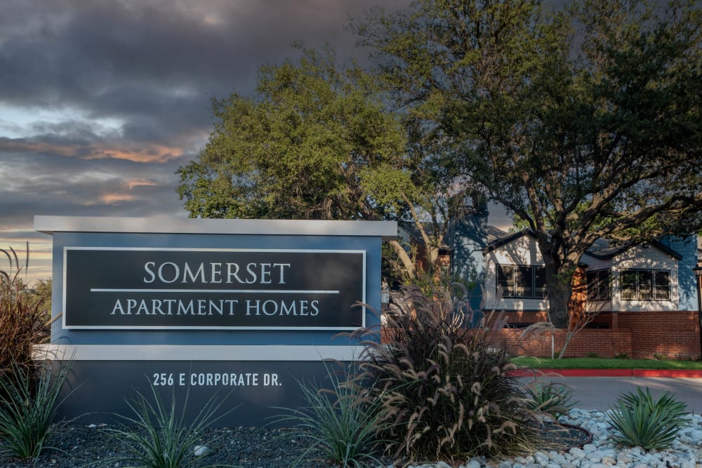 Sign for Somerset Apartment Homes with building backdrop at Somerset