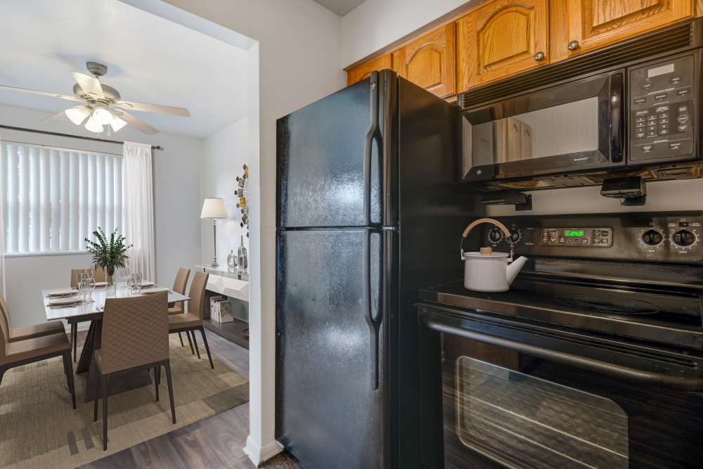Kitchen with black appliances at Brighton Colony Townhomes in Rochester, New York