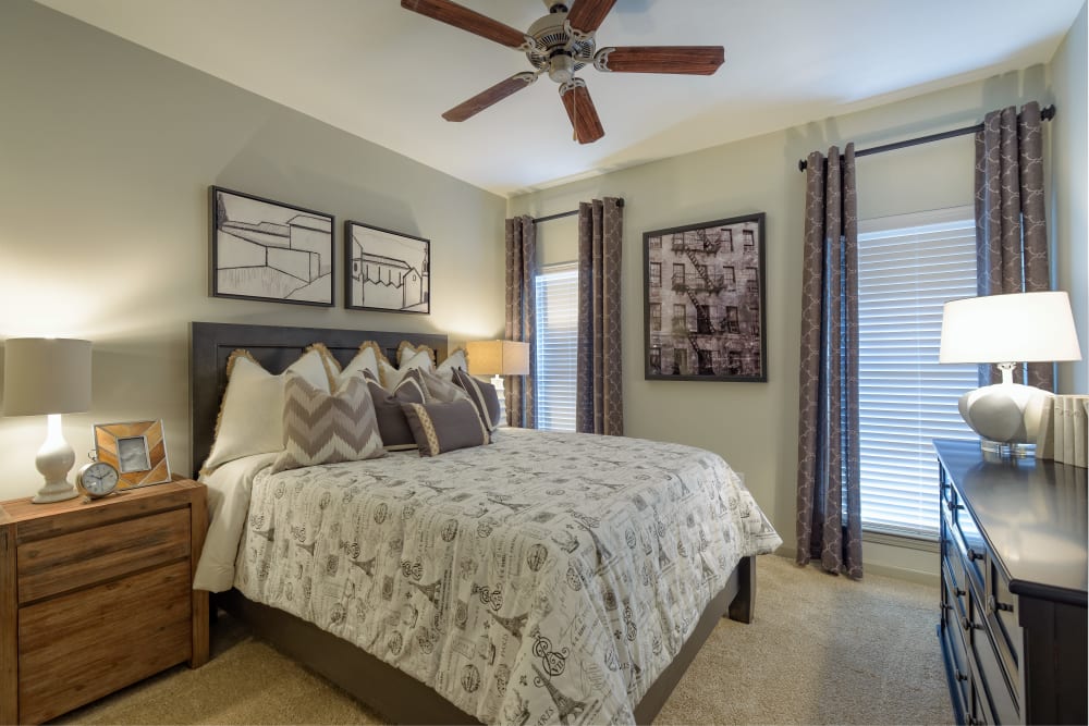 Bedroom with a ceiling fan at Provenza at Old Peachtree in Suwanee, Georgia