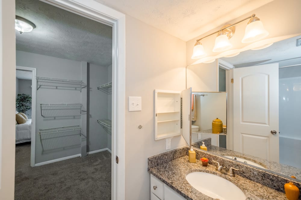 A bathroom leading to a walk-in closet in a model apartment at LaVista Crossing in Tucker, Georgia