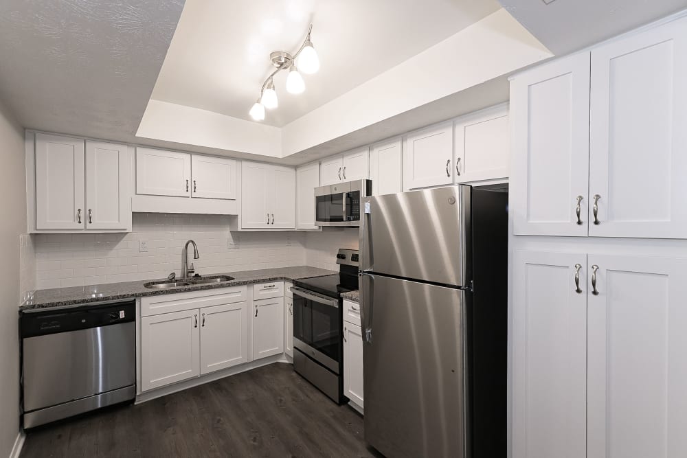 Stainless-steel appliances and white cabinets in an apartment kitchen at LaVista Crossing in Tucker, Georgia