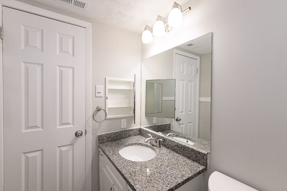 A cabinet next to the sink in an apartment bathroom at LaVista Crossing in Tucker, Georgia