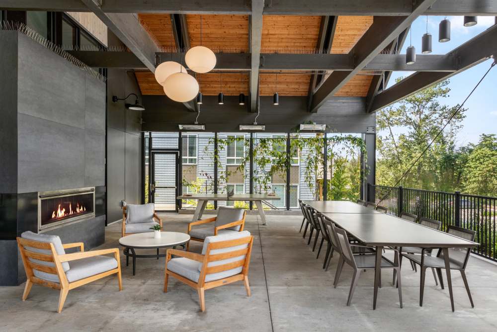 Outdoor lounge area with fireplace at 207 East in Edgewood, Washington