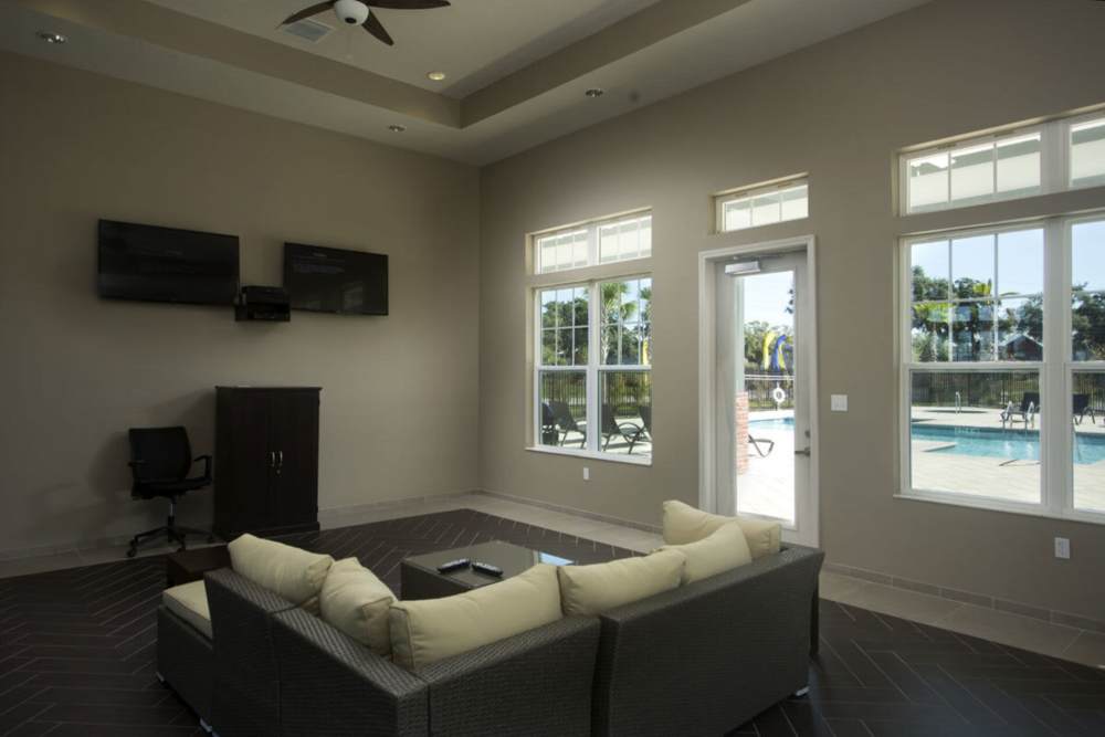 Well-lit clubhouse with view and access to the outdoor pool at The Edge at Brandon in Brandon, Florida