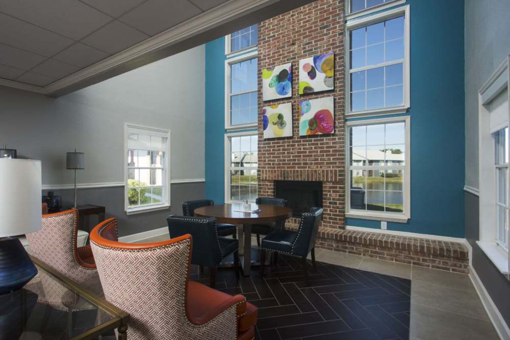 Beautiful clubhouse with seats, fireplace and floor to ceiling window at The Edge at Brandon in Brandon, Florida