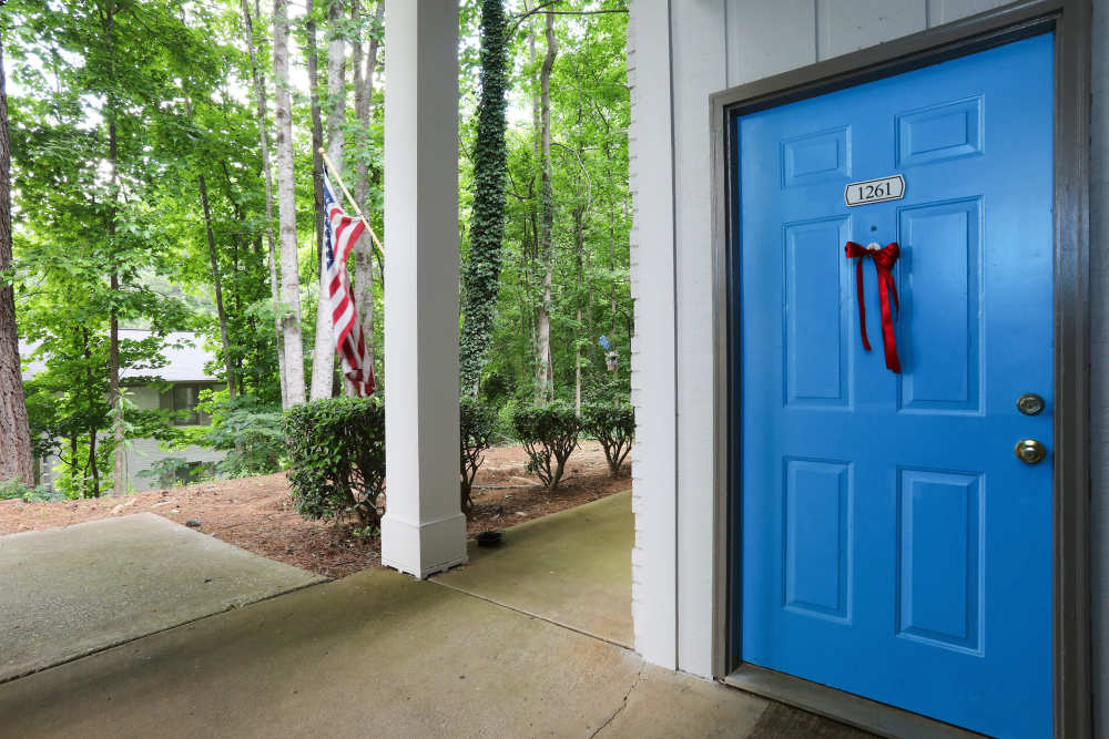 blue door leading into a first story apartment at Britain Village in Lawrenceville, Georgia
