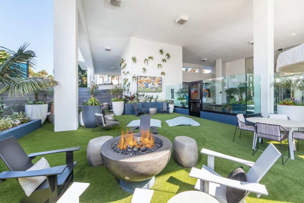 Outdoor seating area with a firepit at 1900 Ocean Apartment Homes in Long Beach,California