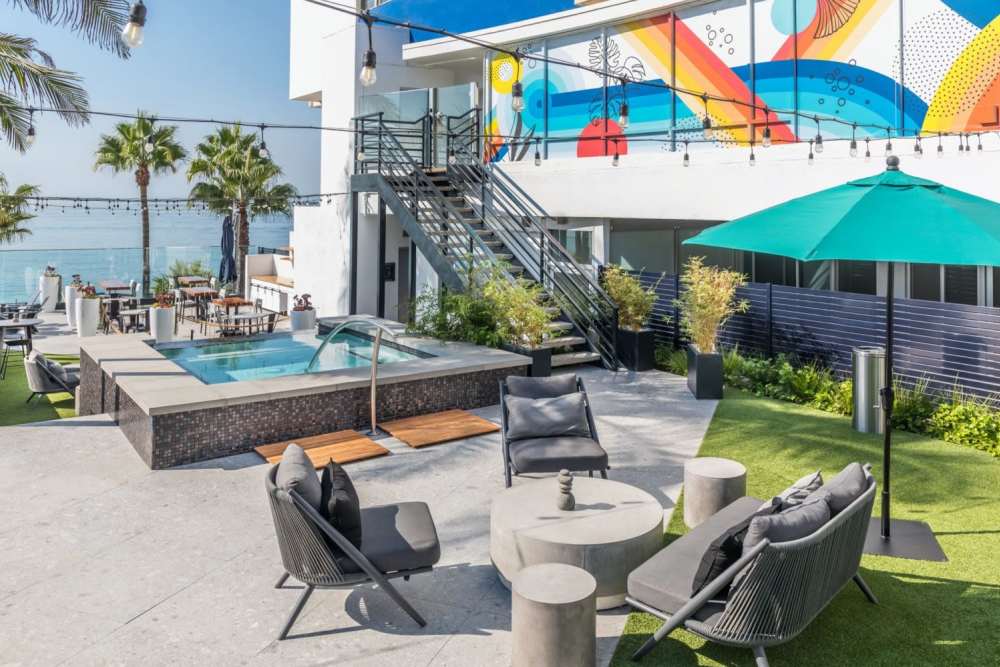 Spa deck with shade seating at 1900 Ocean Apartment Homes in Long Beach,California
