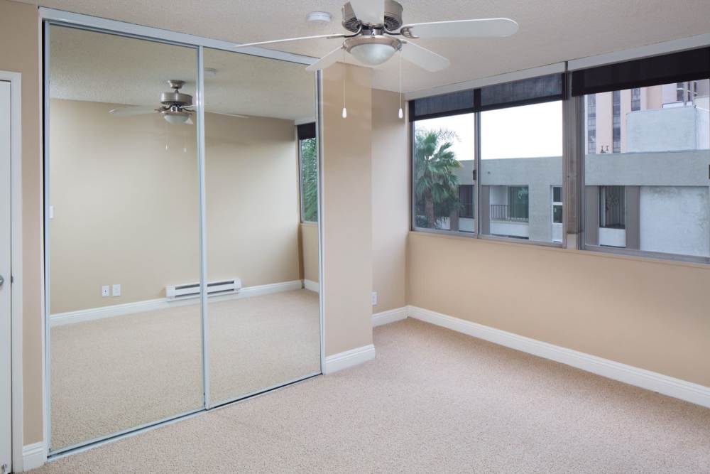Walk-in closets with unique sliding mirror doors at 1900 Ocean Apartment Homes in Long Beach,California