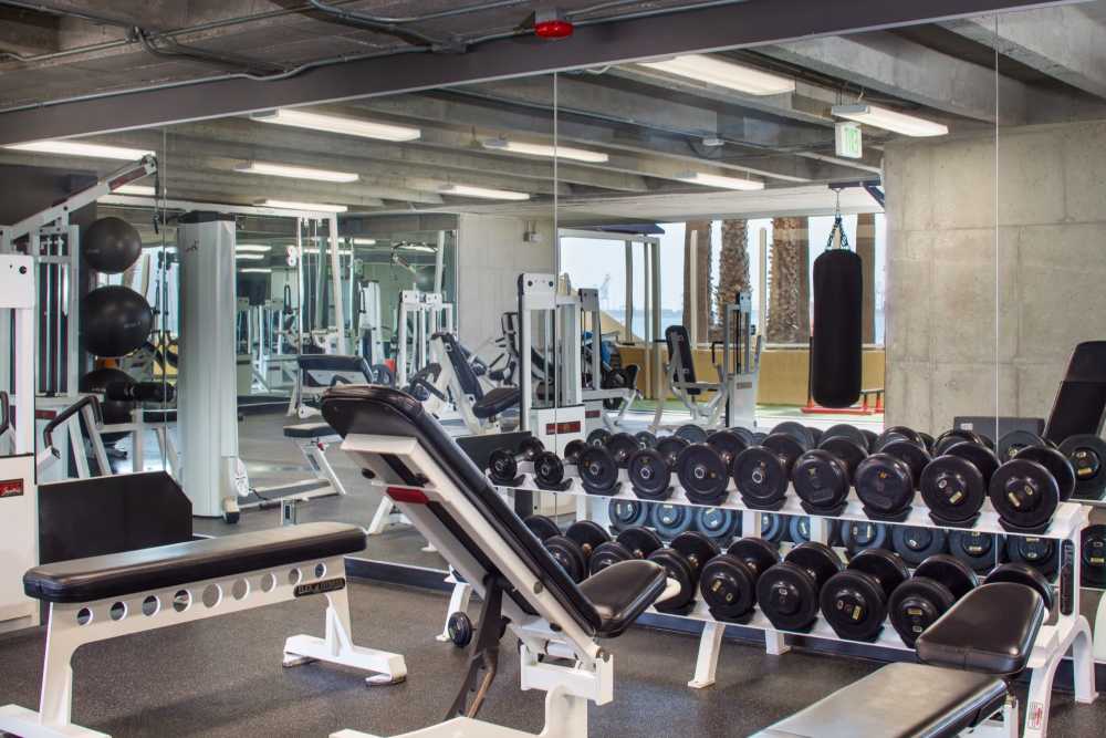 Fitness center with wide range of exercising equipment at 1900 Ocean Apartment Homes in Long Beach,California