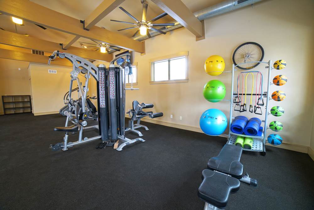 Resident fitness center with weight machines at The Quarters at Lawrence in Lawrence, Kansas