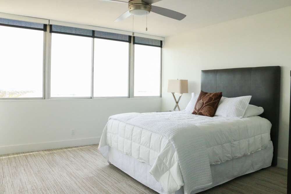 Bright bedroom with large windows at 1900 Ocean Apartment Homes in Long Beach,California