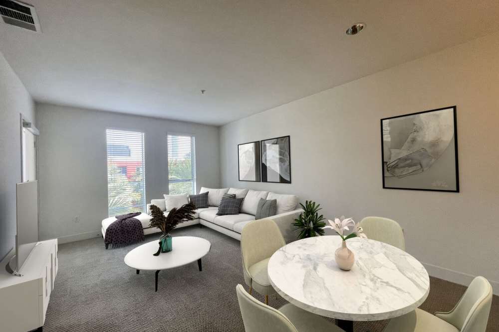 Dining table with a table and chairs at The Marke Apartment Homes in Santa Ana,