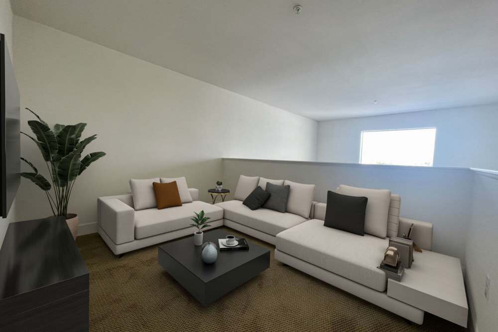 Comfortable couch in the living room at The Marke Apartment Homes in Santa Ana,