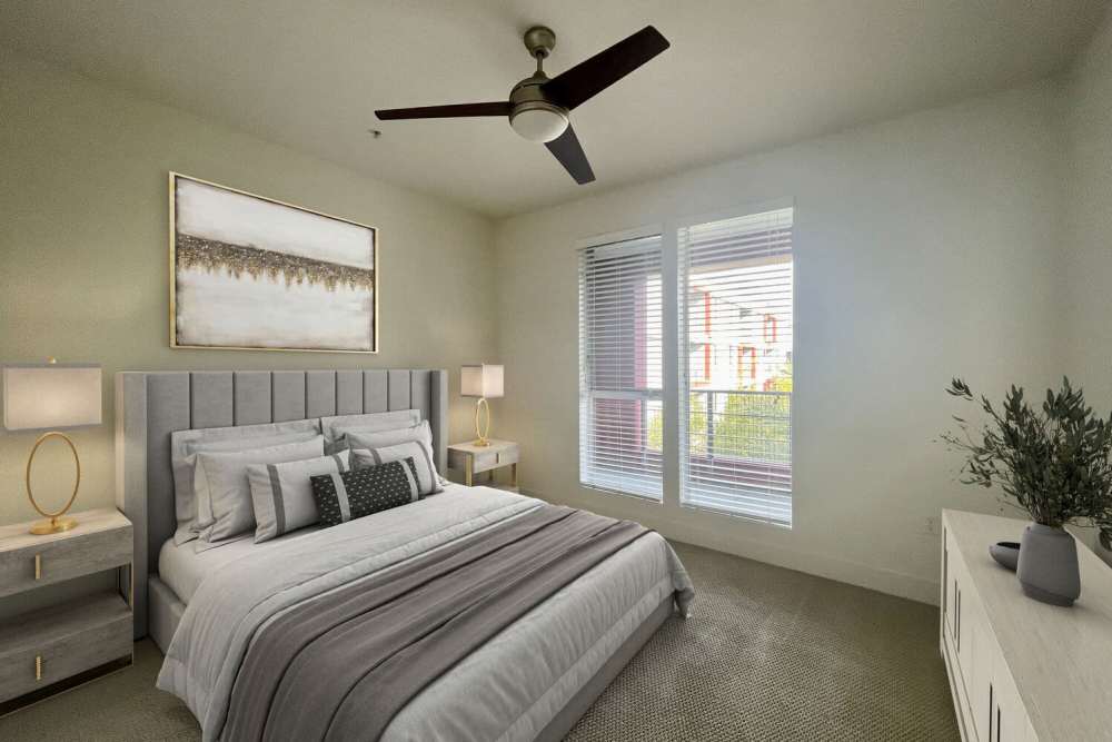 Spacious bedroom with a ceiling fan and a bed at The Marke Apartment Homes in Santa Ana,