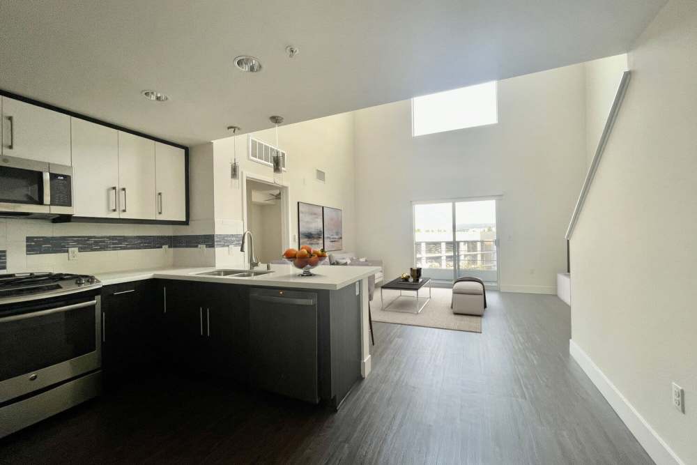 View of the living room from the kitchen at The Marke Apartment Homes in Santa Ana,