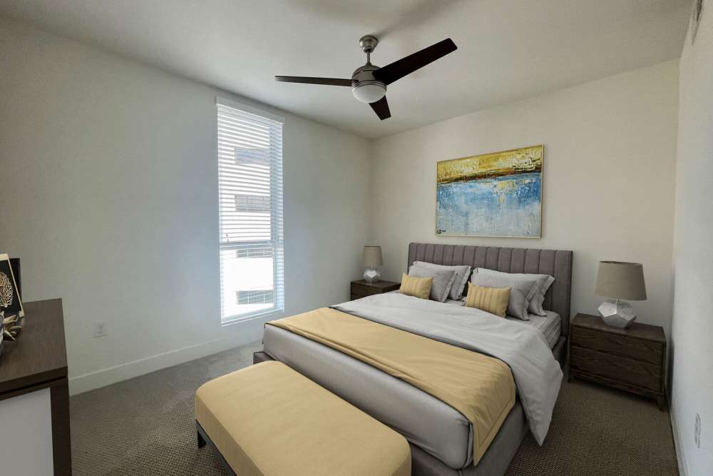 Cozy bedroom with a bed, ceiling fan and a window at The Marke Apartment Homes in Santa Ana, California