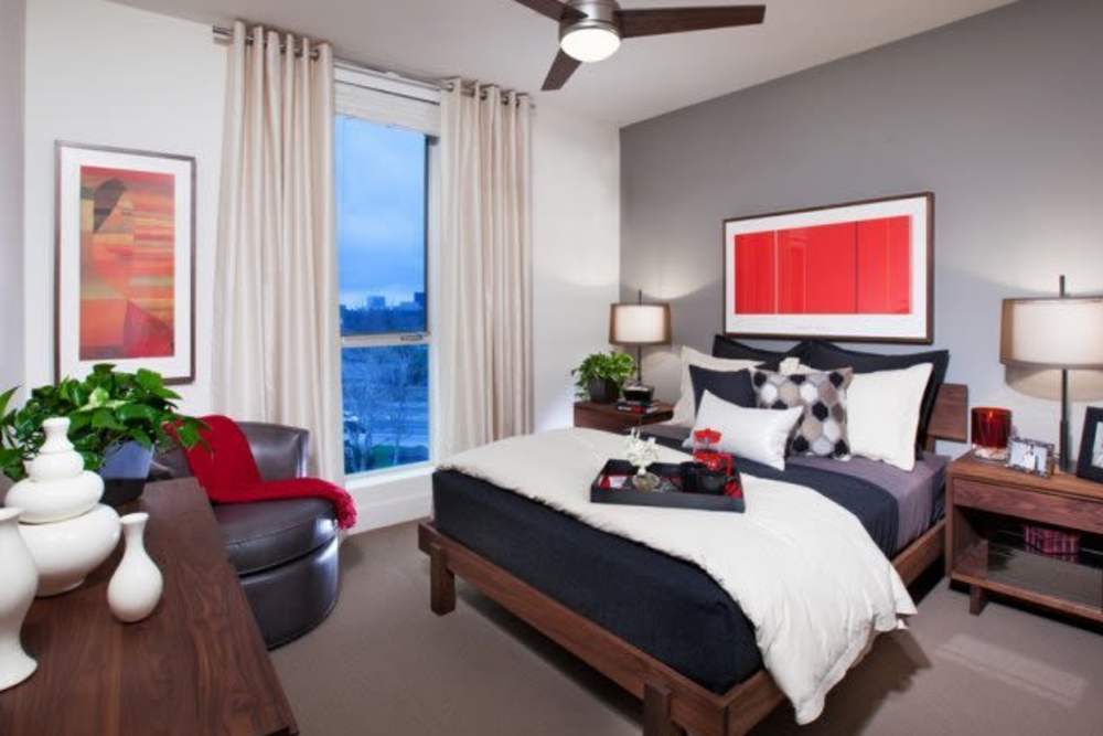 Bedroom with a large window at The Marke Apartment Homes in Santa Ana,