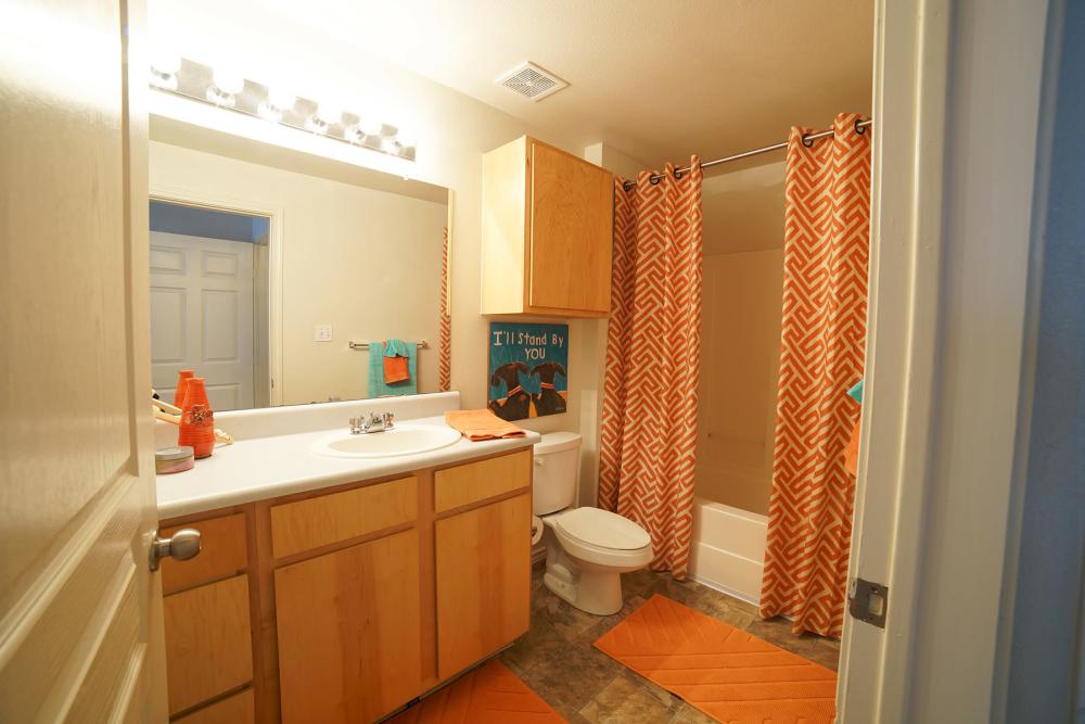 Apartment bathroom with bathtub/shower at The Quarters at Lawrence in Lawrence, Kansas