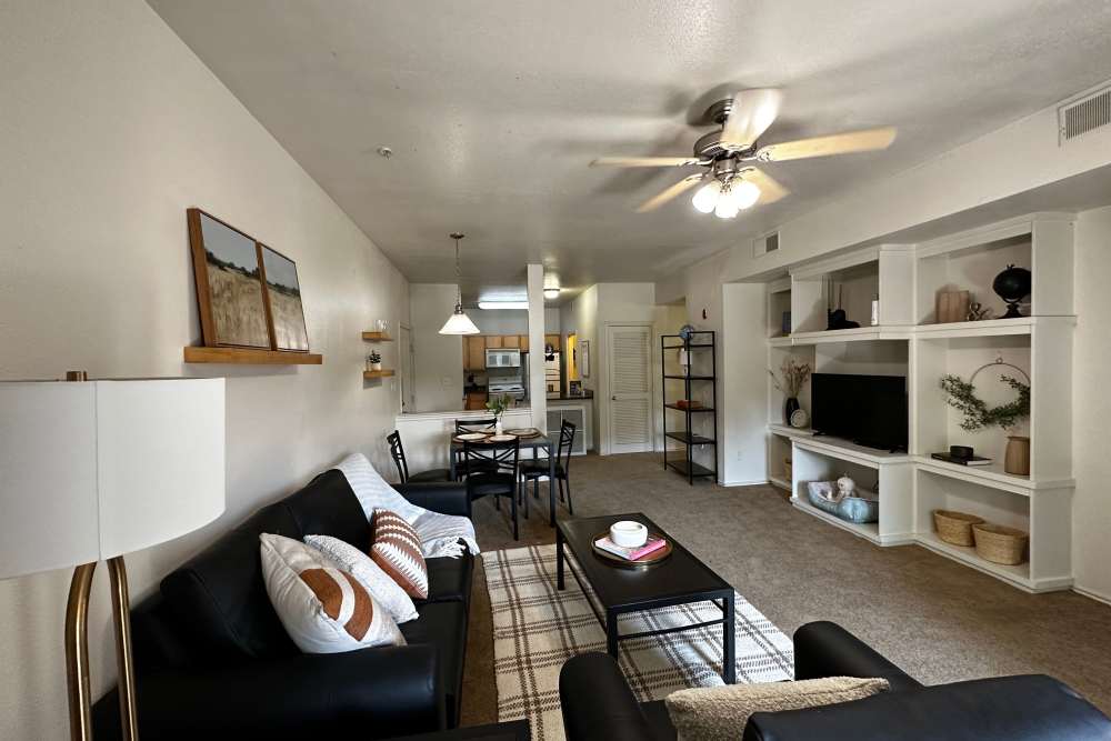 Living room with large entertainment center at The Quarters at Lawrence in Lawrence, Kansas