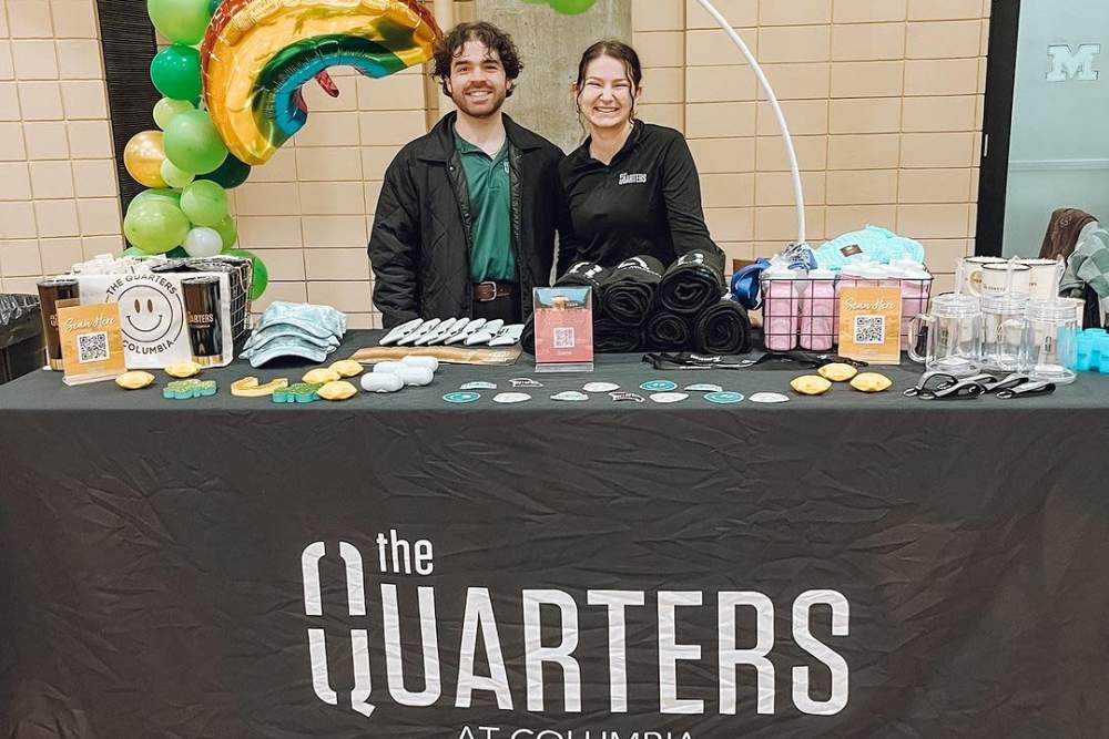 Team members at an event booth at The Quarters at Columbia in Columbia, Missouri