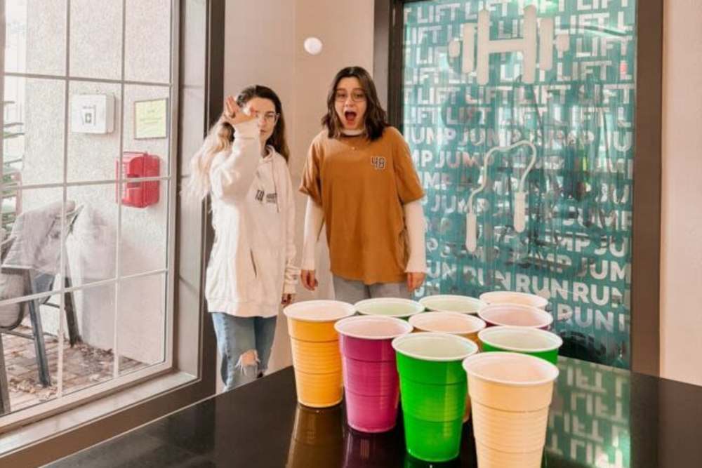 Staff playing cup pong at The Quarters at Lincoln in Lincoln, Nebraska