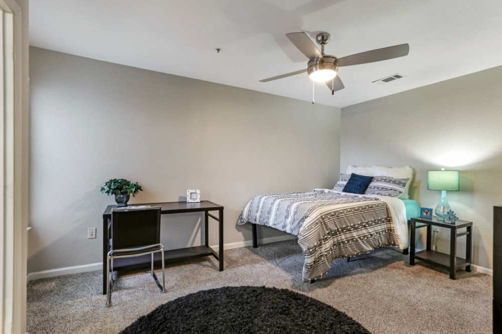 Carpeted bedroom with ceiling fan at Altitude at Baton Rouge in Baton Rouge, Louisiana